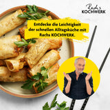 Rachs KOCHWERK Heißluft-Fritteuse Doppelkorb 2x 3,5l schwarz mit knackigen Frühlingsrollen und Kräutern auf Teller.