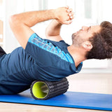 Mann nutzt #DoYourFitness Faszienrolle Ishana Graffiti Mittel-hart Braun/Blau zur Muskelentspannung und Faszientraining auf Yogamatte.