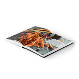 Kochwerk Buch für die Heißluft-Fritteuse mit Rezepten und Tipps, offen mit Bild von knusprigen Süßkartoffelpommes und Dip.