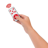 Hand hält Fernbedienung der VfB Stuttgart LED-Echtwachskerze - Mit rotierendem VfB-Wappen - rot für Timer und Geschwindigkeit.