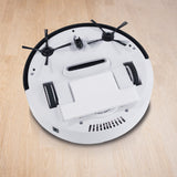 MAXXMEE Saugroboter - Bis zu 60 Minuten Einsatzzeit - weiß/schwarz, Rückansicht mit Bürsten auf hellem Holzboden.